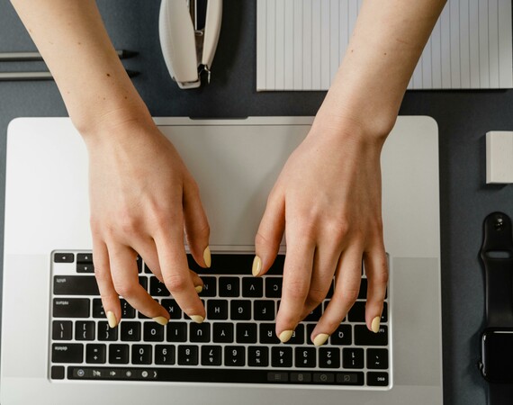 Learner using laptop close up of hands